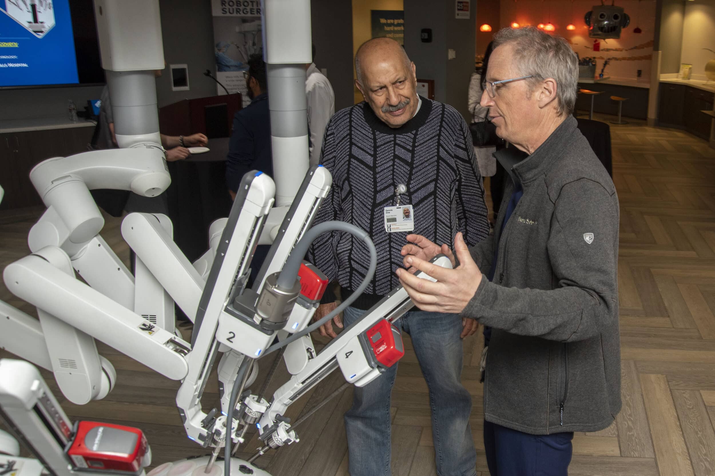Dennis Zine and Dr. Schreier with Da Vinci Patient cart