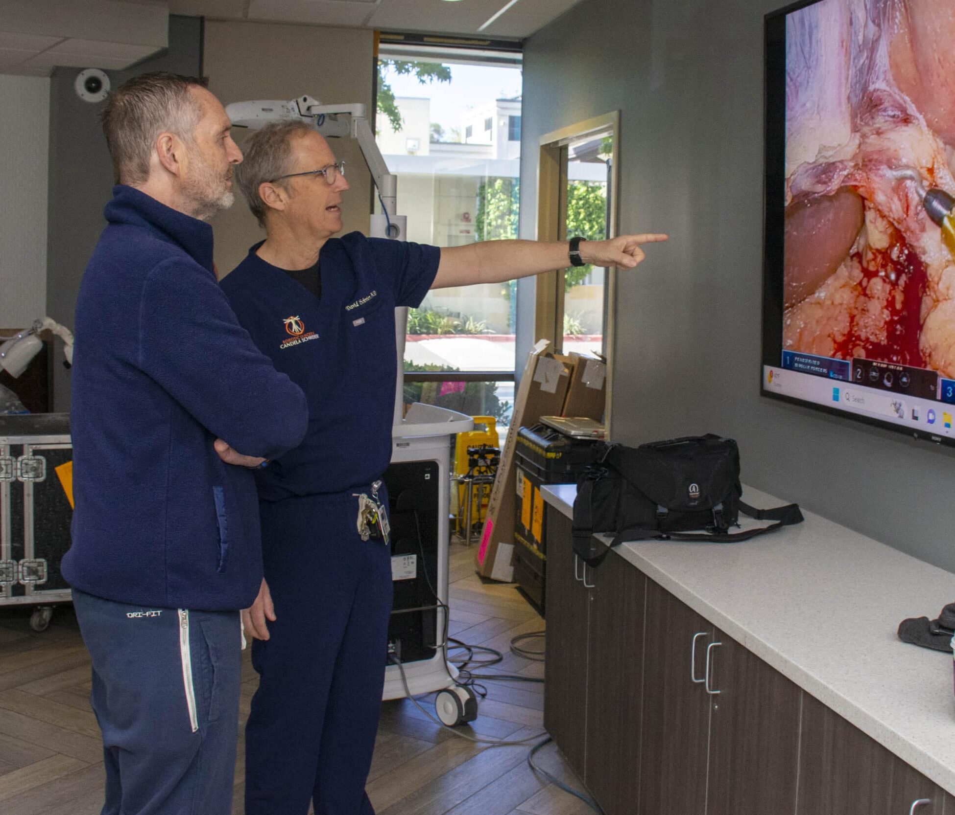 Dr. Schreier showing surgery to robotic surgery patient